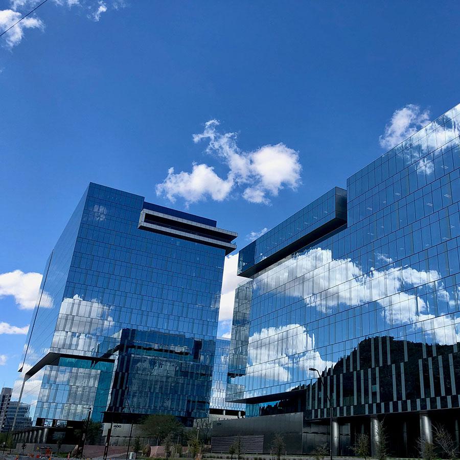 The State Farm office buildings reflecting the sky above them.